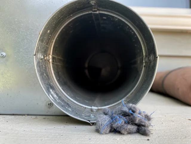 Cleveland Heights Dryer Vent Cleaning technician using specialized equipment to clear severe dryer vent blockage in Cleveland Heights